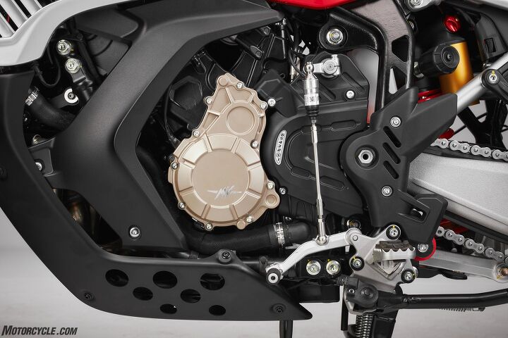 From the shock adjustment knobs, to the interesting frame cutouts, plastic paneling designed for air flow, and large skid plate, there’s a lot to unpack in this photo. Oh, and the center stand is standard fare.