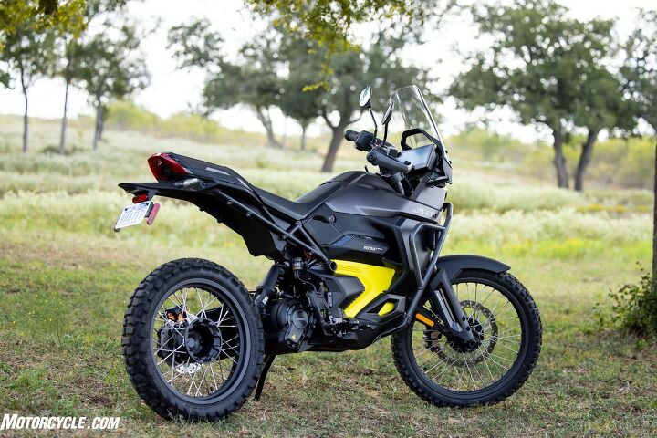 Big, wide, serrated footpegs on the Origin ensure your boots don't slip in the wet. The Rotax E-Power motor is actually part of the single-sided swingarm, pivoting on steel plates bolted to the lower part of the battery case. Rear KYB HPG shock is adjustable for spring preload and rebound/compression damping.